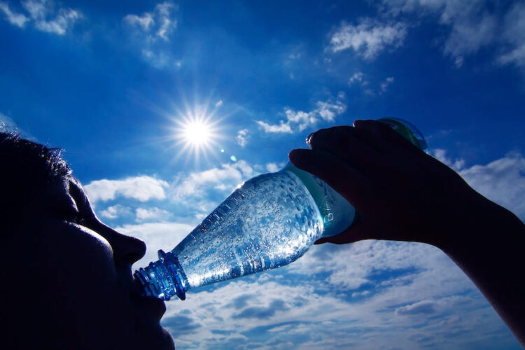 Frau trinkt Wasser aus der Flasche