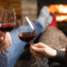Paar mit Rotwein vor dem Kamin