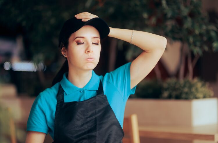 Erschöpfte junge Kellnerin